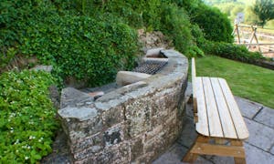 Feature stone BBQ enjoy time with family and friends  at River Wye Lodge sleeping 26 Nr. Forest of Dean Gloucestershire www.bhhl.co.uk