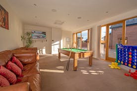 Games room with bluetooth surround sound and a pool table