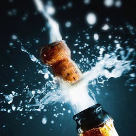 A bottle opening to celebrate New Year 2022