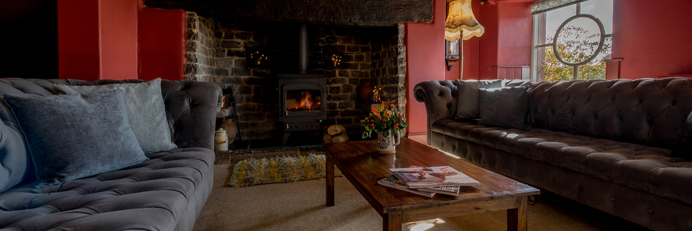 Cosy fireside afternoon in the snug; with chesterfield sofas and coffee table