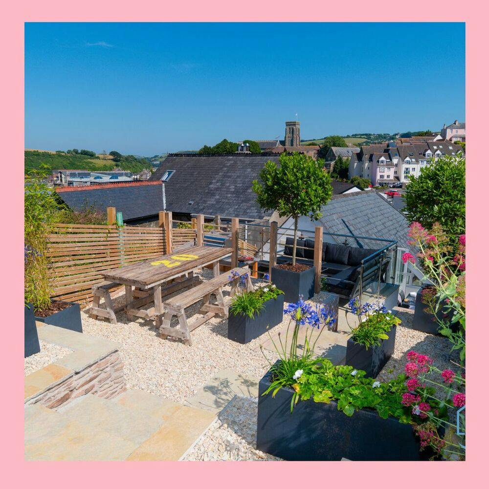 A bordered image of a sandy Salcombe beach and a wide variety of beautiful houses