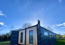 Bespoke, converted shipping container with striking, cedar cladding  