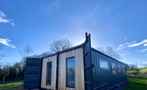 Bespoke, converted shipping container with striking, cedar cladding  