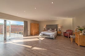 Inwood Farmhouse - Bedroom 5 (Sky Lane): A superking bed, a free standing bath, en suite shower room and veranda