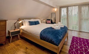 Pink Thatch - Bedroom 1 has full height windows giving views of the Wiltshire countryside