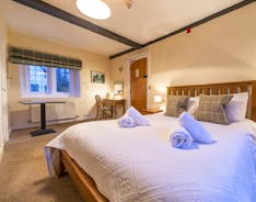 A double bedroom with picture window and beams at Forest house, an 11 en suite bed whole house holiday let at Coleford - www.bhhl.co.uk