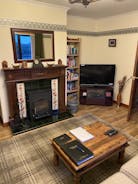 Antique fireplace with newly fitted log stove.