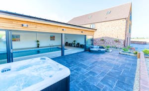 The Granary - The pool room opens out onto a sunny patio with a hot tub