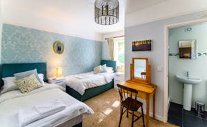 A pretty pale blue twin bed with en suite at Forest House in the Wye Valley, a whole house holiday let with 11 beds.  - www.bhhl.co.uk