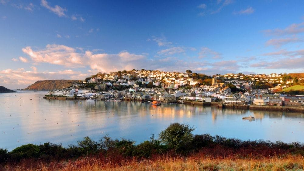 An outstanding view of Salcombe near the clear, calm sea on a lovely sunny evening