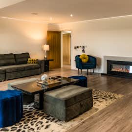 The TV is projected onto the wall above the fireplace, providing a clear view from every corner of the room. The TV is projected onto the wall above the fireplace, providing a clear view from every corner of the room.