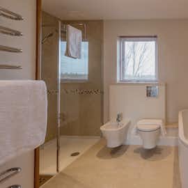 Herons Bank - The main bathroom has a walk-in shower and a big bath tub Herons Bank - The main bathroom has a walk-in shower and a big bath tub