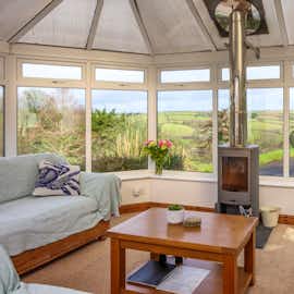 Conservatory with woodstove and sea view Conservatory with woodstove and sea view