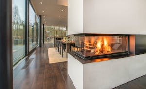The Glass House - A glass walled wood-burner separates the dining and living areas