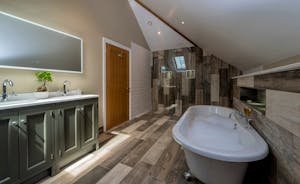 Croftview - Bedroom 10 (Barn Owl) has an ensuite with a free standing bath and separate shower