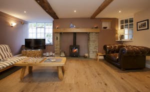 The cosy sitting room features a wood burning stove to keep you toasty in the winter months.