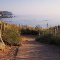 Pathway in Hope Cove leading to stunning views of the sea and a beach