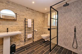 Withymans - Bedroom 6: Original stone wall in the en suite wet room