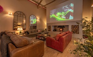 Huge 3m movies can be viewed above the roaring fire, perfect ambience for a movie night