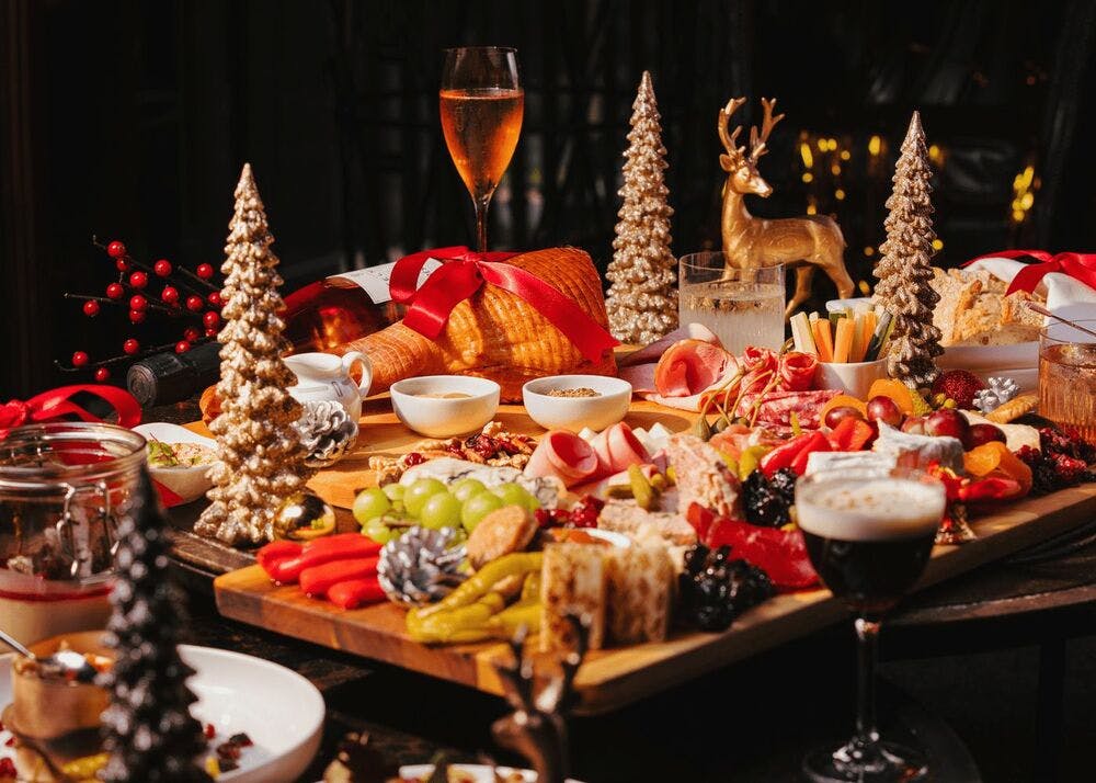 a table laden with Christmas food, drink and decor