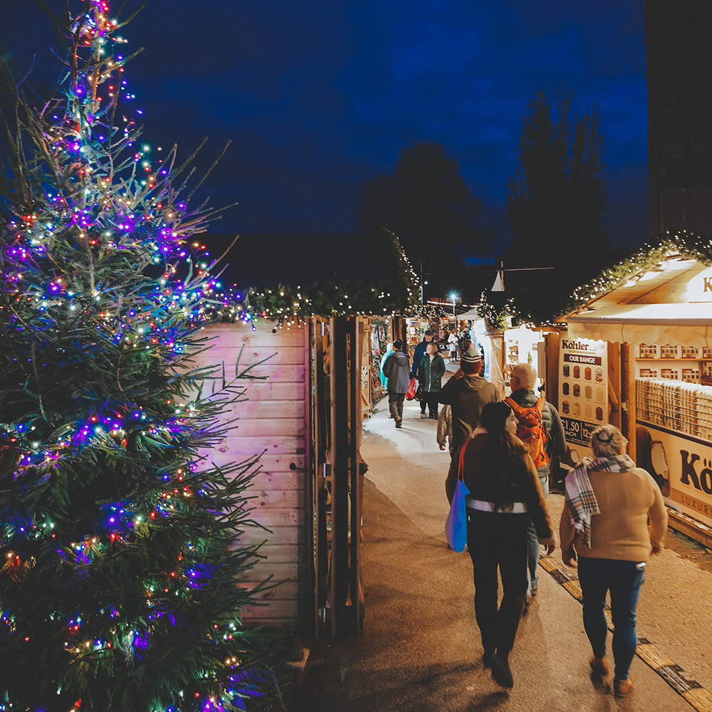 Twinkling lights in front of a wooden chalet at Exeter Christmas Market
