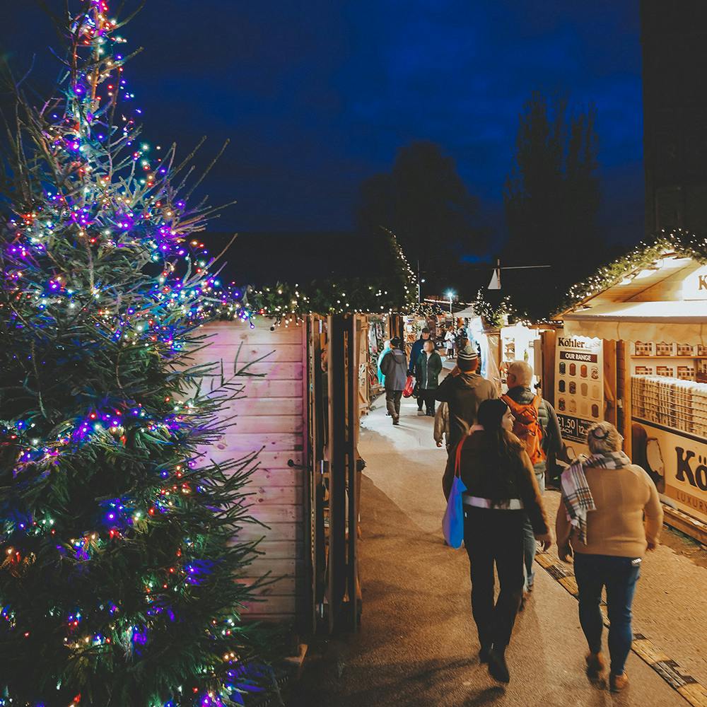 Twinkling lights in front of a wooden chalet at Exeter Christmas Market