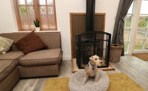 The lounge area with a wood burner cosy and warm even for the dog 