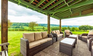 Orchard House outdoor seating area showcasing the open countryside views surrounding the house.  - www.bhhl.co.uk