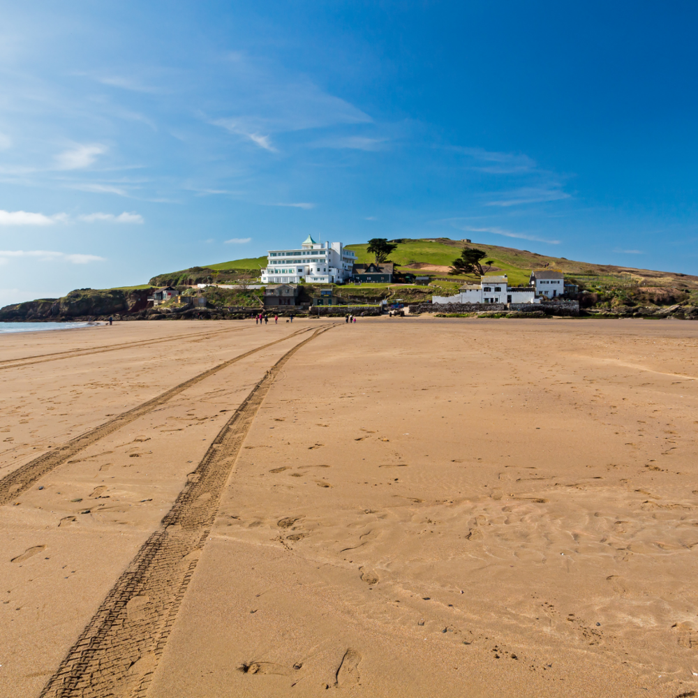 Bantham and Bigbury-On-Sea stunning and sandy beach with tire trails on a sunny day