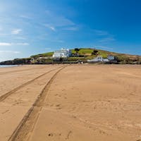 Bantham and Bigbury-On-Sea stunning and sandy beach with tire trails on a sunny day