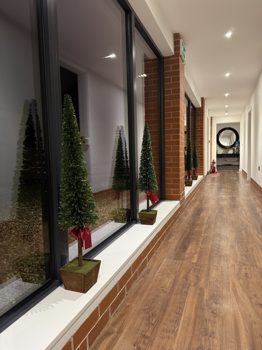 The hallway in Churchill showing miniature Christmas trees in the windows 
