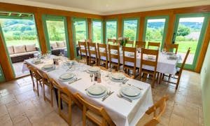 Orchard House dining room with flag tiled floor, fabulous views and two tables set for 16 guests, seats 24 over all Monmouthsire www.bhhl.cu.uk 