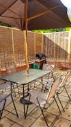 Enclosed Courtyard with patio chairs and Gas BBQ