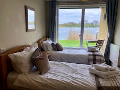 Goose Nest House Twin bedroom overlooking Somerford Lagoon