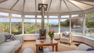 Conservatory with woodstove and sea view
