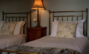 Hurstone: Bedroom 4 - Twin brass beds, florals and woollens