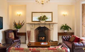 The Old Rectory - A light and airy sitting room with a beautiful fireplace as a focal point