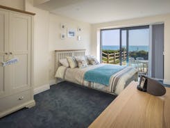 Bedroom 3 with access to garden and sea views