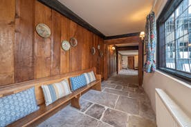 Luntley Court: Original oak panelling and flagstone floor in the long hallway