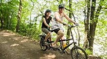 A couple ride a tandem along the Peregrine Path in the Wye Valley