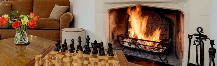 The roaring log fire in the sitting room at The Cottage Beyond