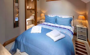 Hamble House - Bedroom 7: A double bed, en suite shower room, and separate seating area
