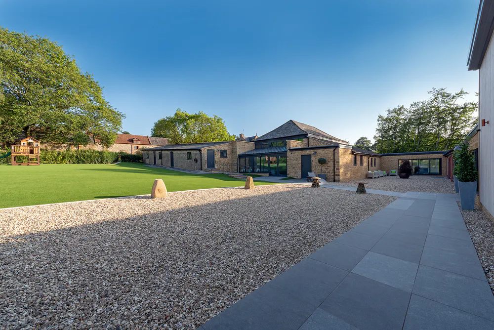 Enclosed outside area with artificial grass and children climbing frame