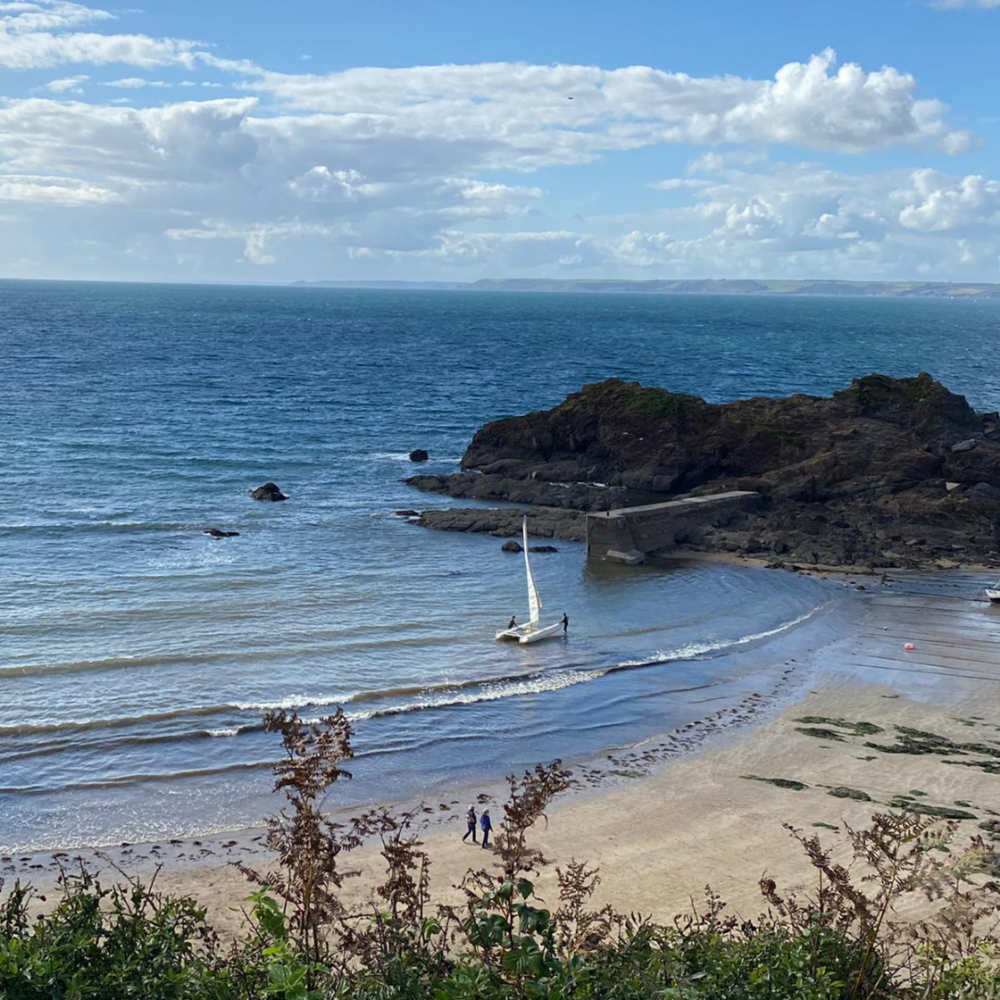 Wonderful view of a sandy beach, clear sea and rocks on Hope Cove