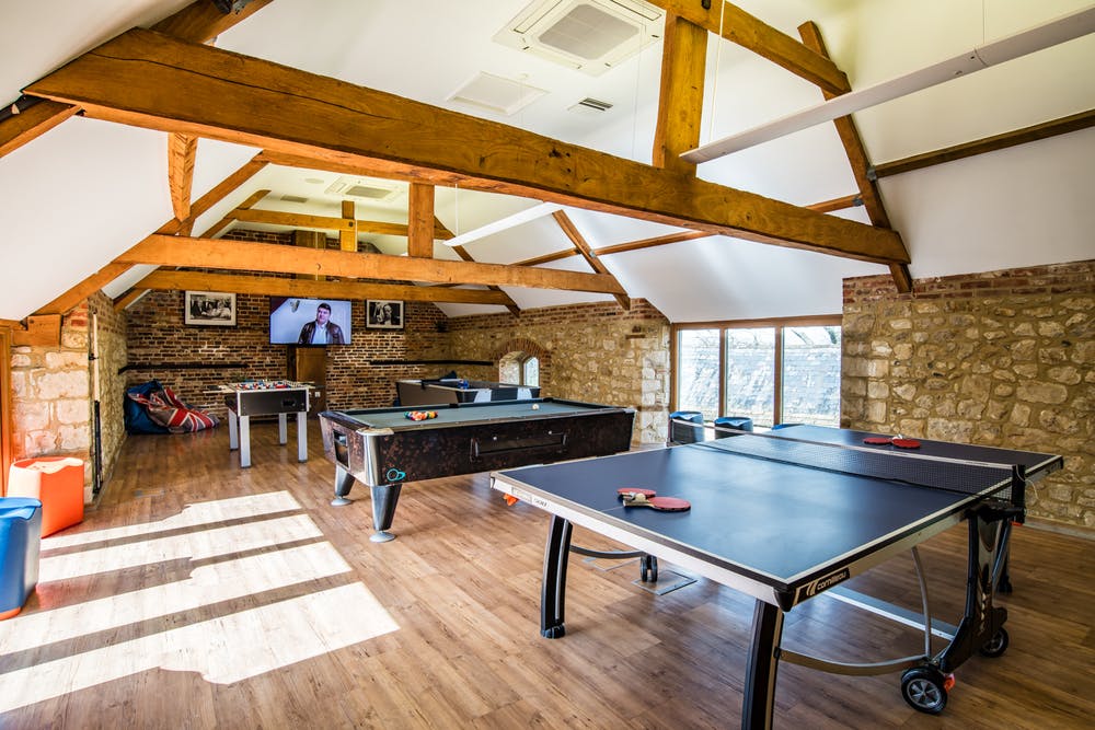 Beaverbrook games room with large tv, pool table, table tennis, air hockey and table football