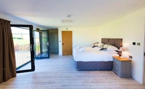 The Granary - Bedroom 2 is a large light and airy room, with French doors and a Juliette balcony