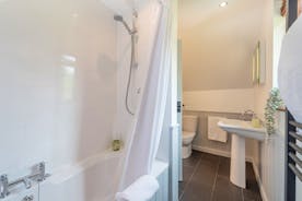 Flossy Brook - The ensuite bathroom for Bedroom 2, with a bath and overhead shower