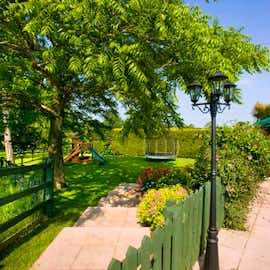 Millgrove House: The children's play area is fenced, secure and grassed Millgrove House: The children's play area is fenced, secure and grassed