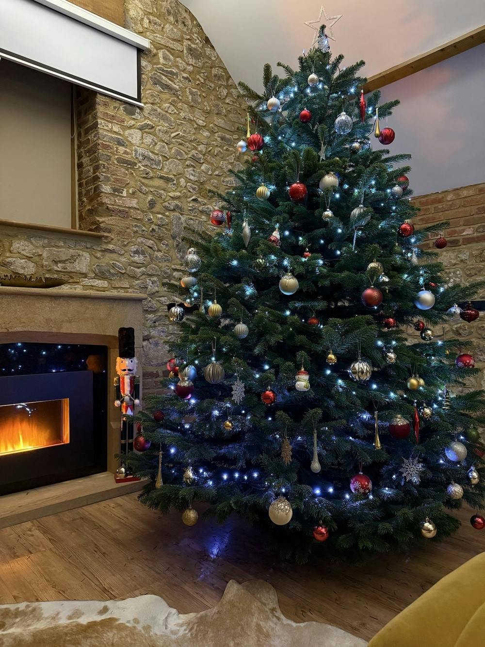 Large and fully decorated Christmas tree in Beaverbrook living room