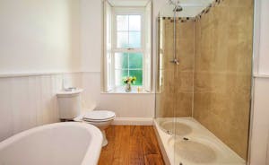 Sandfield House - The main bathroom has a roll top bath and a big shower